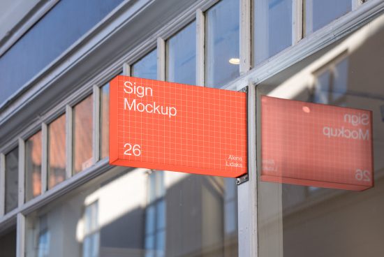 Outdoor storefront sign mockup template with an orange grid design placed on a building. Ideal for designers. Categories: Mockups, Graphics, Templates.