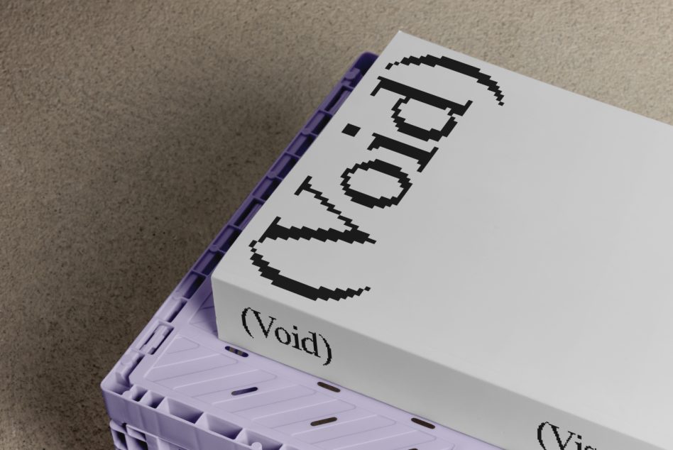 Pixelated glitch font on white box with purple binding, sitting on textured surface