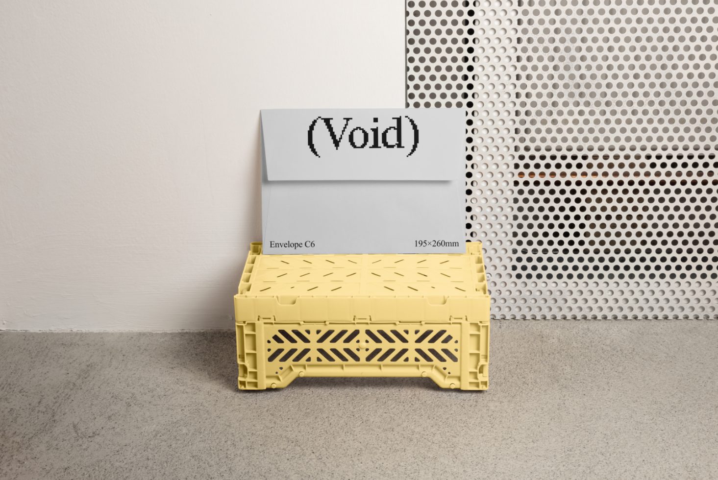 Mockup of a C6 envelope with the text Void leaning against a wall, placed on a yellow plastic crate. Keywords: Mockup, C6 envelope, design asset, graphic template.