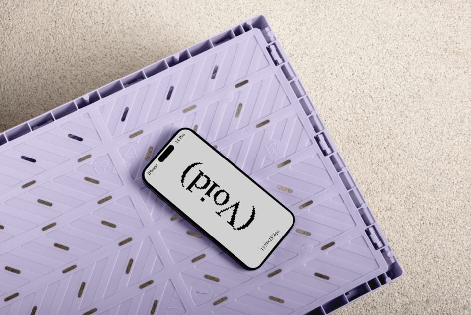 iPhone 14 Pro resting on lavender plastic crate with pixelated text mockup