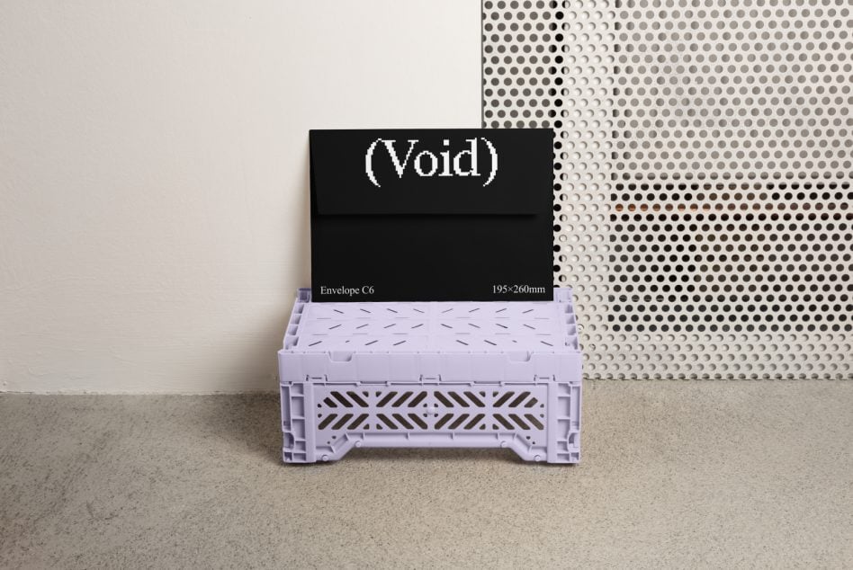 C6 envelope mockup in black with pixelated logo on lavender shipping crate