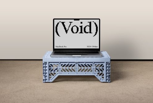 MacBook Pro mockup on a stylish plastic crate table showing bold void digital design for showcasing graphics templates fonts mockups for designers.