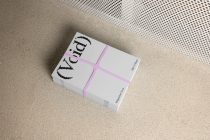 Magazine cover stack with light gray finish, void branding, pink elastic bands