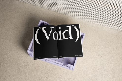 Open magazine with the word Void on black pages, placed on a crate. Ideal for mockup designers, magazine layouts, custom typography, 195x260 mm template.