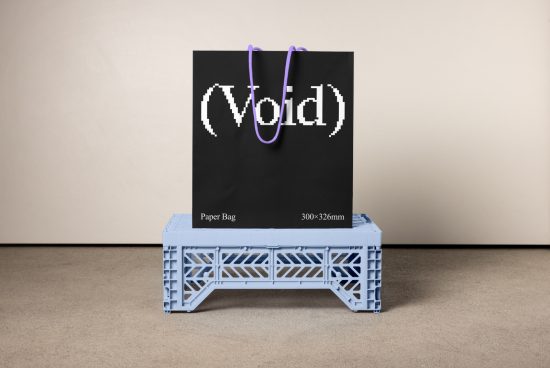 Mockup of a black paper bag featuring the design Void with purple handles placed on a blue plastic stand. Ideal for showcasing branding and packaging designs.