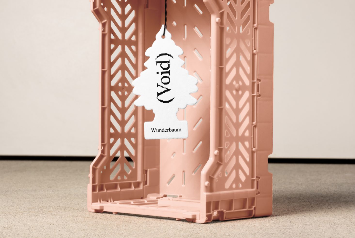 Air freshener with the word Void hung in a decorative pink plastic crate. Perfect for mockups, graphic design, and creative templates for designers.