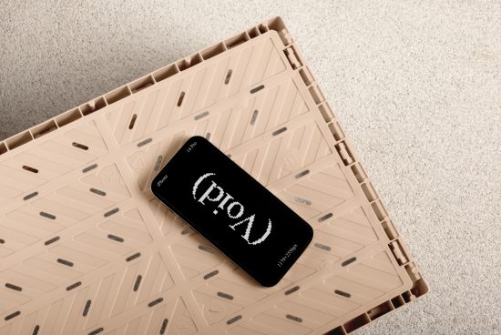 Top view of an iPhone 14 Pro with a retro-style font on screen placed on a beige plastic textured surface. Ideal for mockup and graphic design projects.