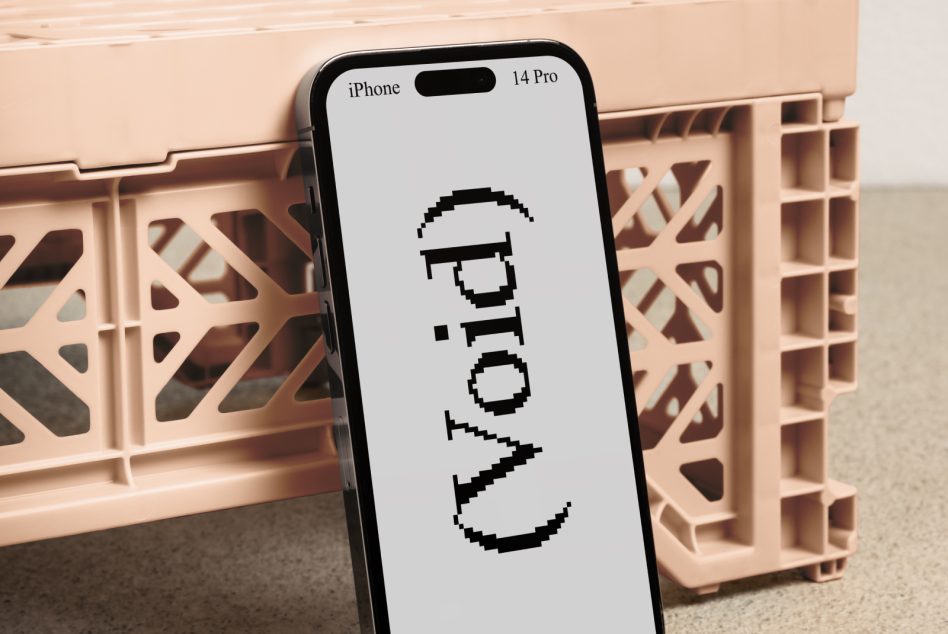 Mockup of an iPhone 14 Pro with a retro pixel font on screen leaning against a beige plastic crate perfect for showcasing digital designs fonts and templates.