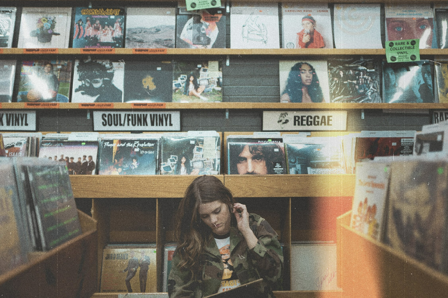 A person browsing vinyl records in a retro-style record store, with soul, funk, and reggae vinyl covers displayed. Ideal for designers seeking mockups and graphics.