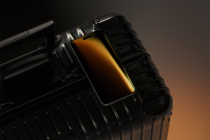iPhone mockup on dark luggage with warm gradient screen display