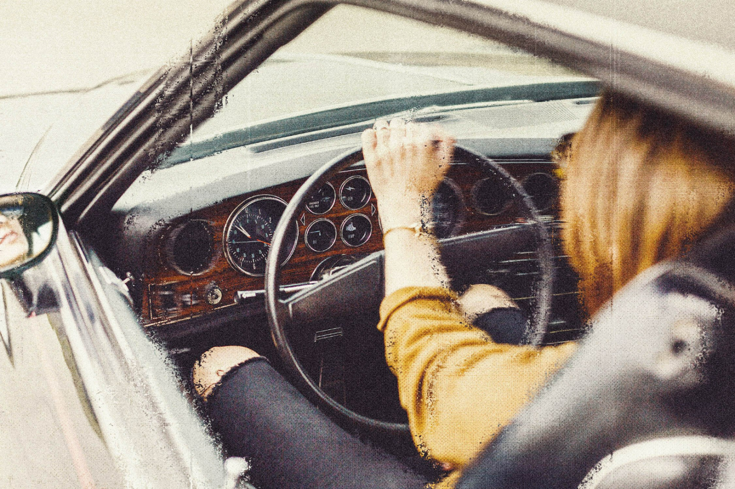 Vintage car interior mockup featuring a person driving, showcasing dashboard design and retro aesthetics. Ideal for automotive graphics and design projects.