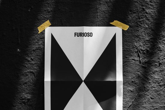 Folded black and white geometric poster taped on dark textured wall. Ideal for graphic design, mockups, templates, backgrounds, branding, and art projects.