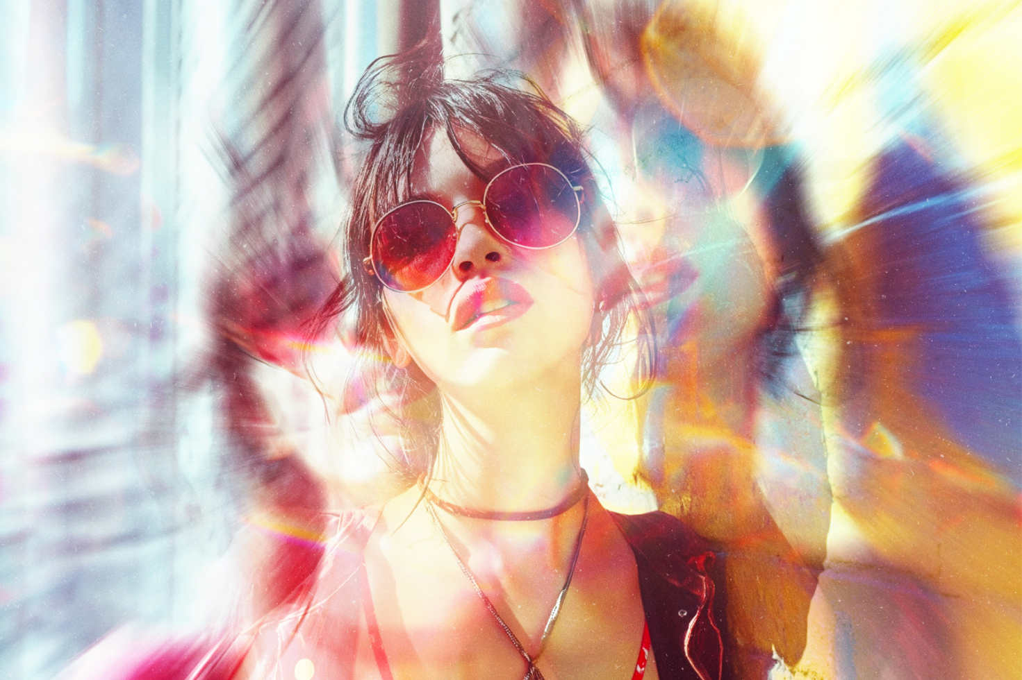 Trippy portrait of a woman with sunglasses and colorful light effects ideal for graphics design backgrounds or mockup presentations in creative projects.