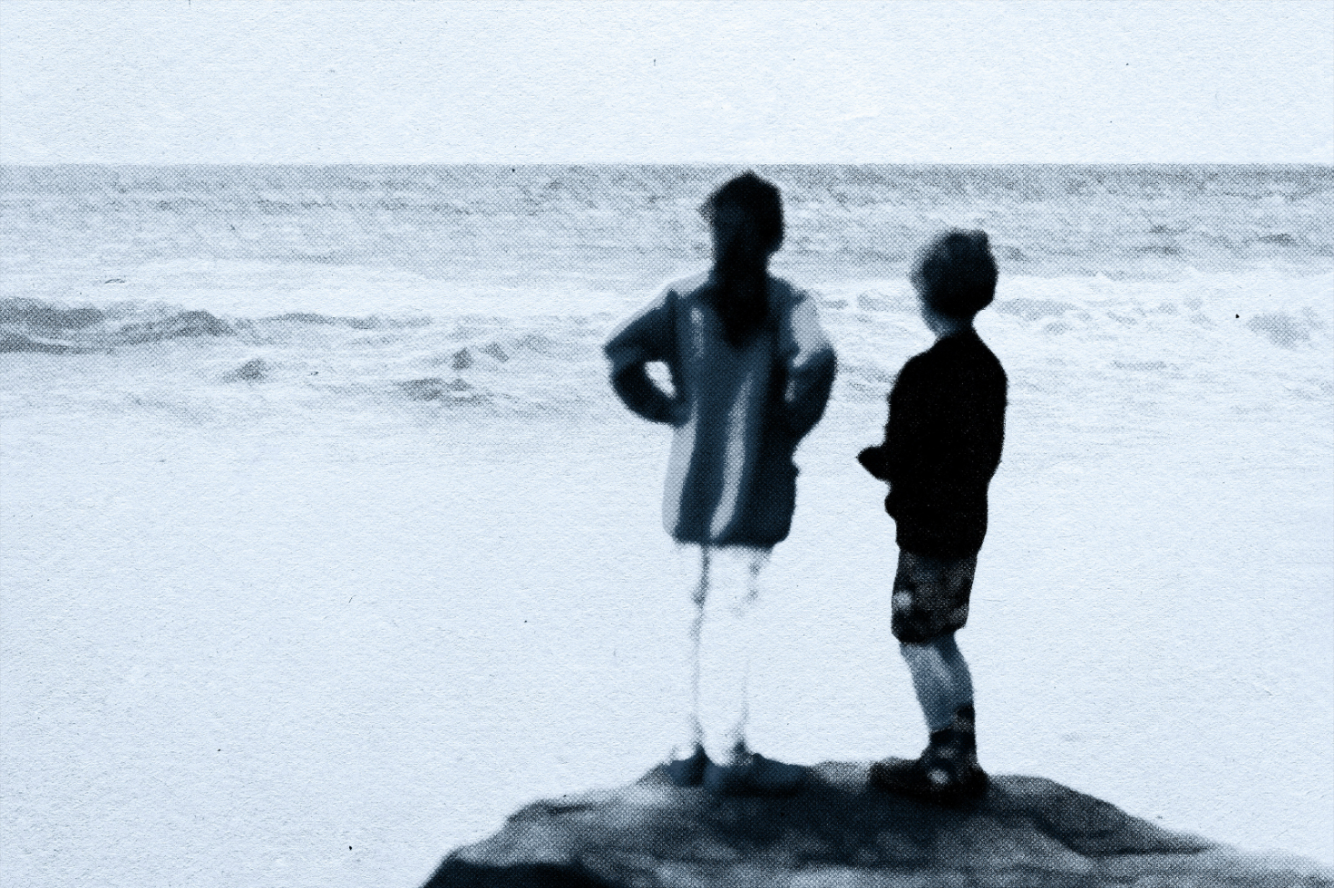 Blurred textured beach scene with two children standing on a rock vintage style suitable for graphic design mockups digital assets for designers