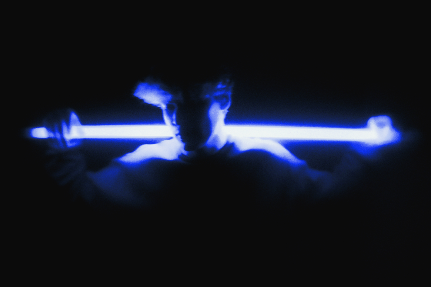 Person holding bright blue neon light bar in a dark room with blurred effect futuristic graphic mockup digital assets for designers moody lighting scene