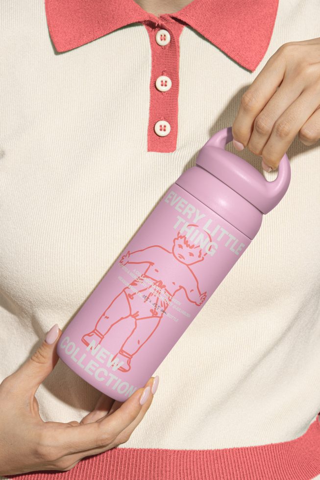 Pink insulated water bottle mockup held by person in cream and pink sweater. Perfect for digital design assets, showcasing graphics and typography.