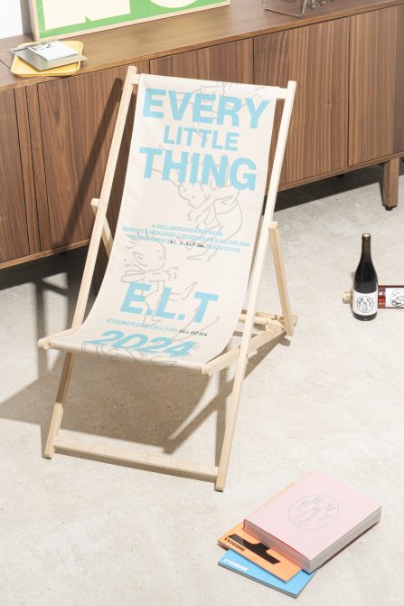 Beach chair mockup with text Every Little Thing beside wooden cabinet in modern setting. Ideal for showcasing design templates for designers.