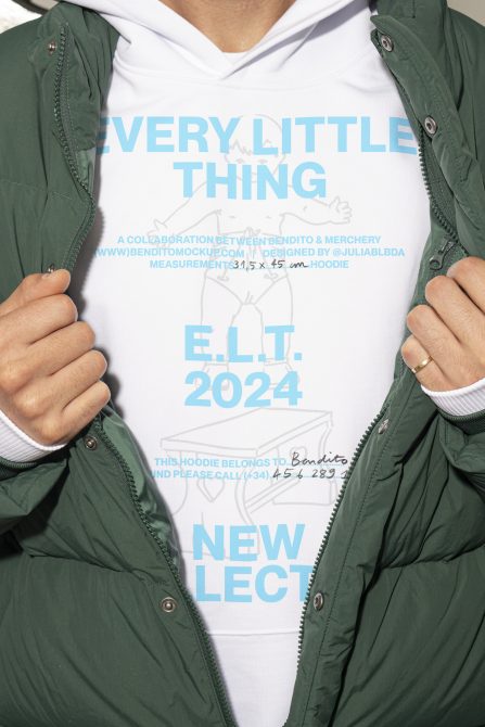 Hoodie mockup featuring bold blue text and design elements on a white background, showcased by a model in a green jacket. Perfect for apparel branding templates