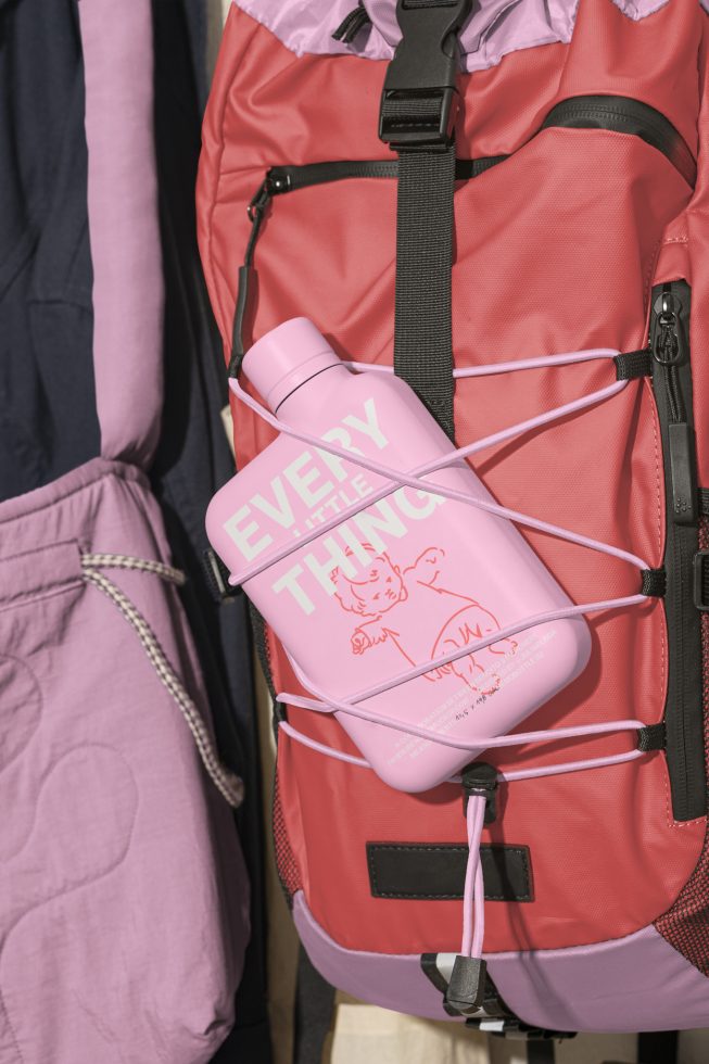 Pink water bottle with text Every Little Thing on a red and pink backpack. Ideal for mockup designs, apparel graphics, and outdoor gear templates.