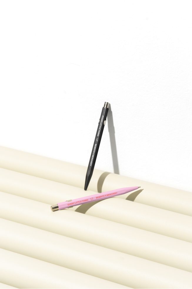 Pink and black pens on a white tubular surface mockup for designers. High-quality pens, minimalistic design ideal for branding projects and stationery graphics.