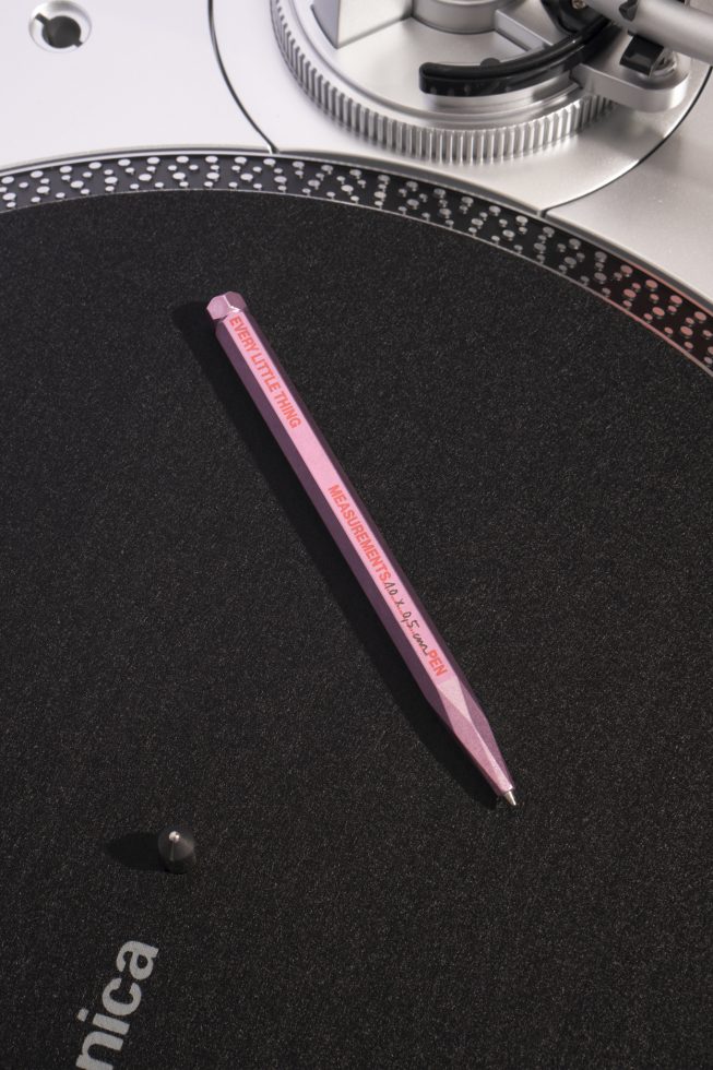 Close-up of a pink pen on a black surface, likely a mockup for product displays or graphic design presentations on a digital assets marketplace.