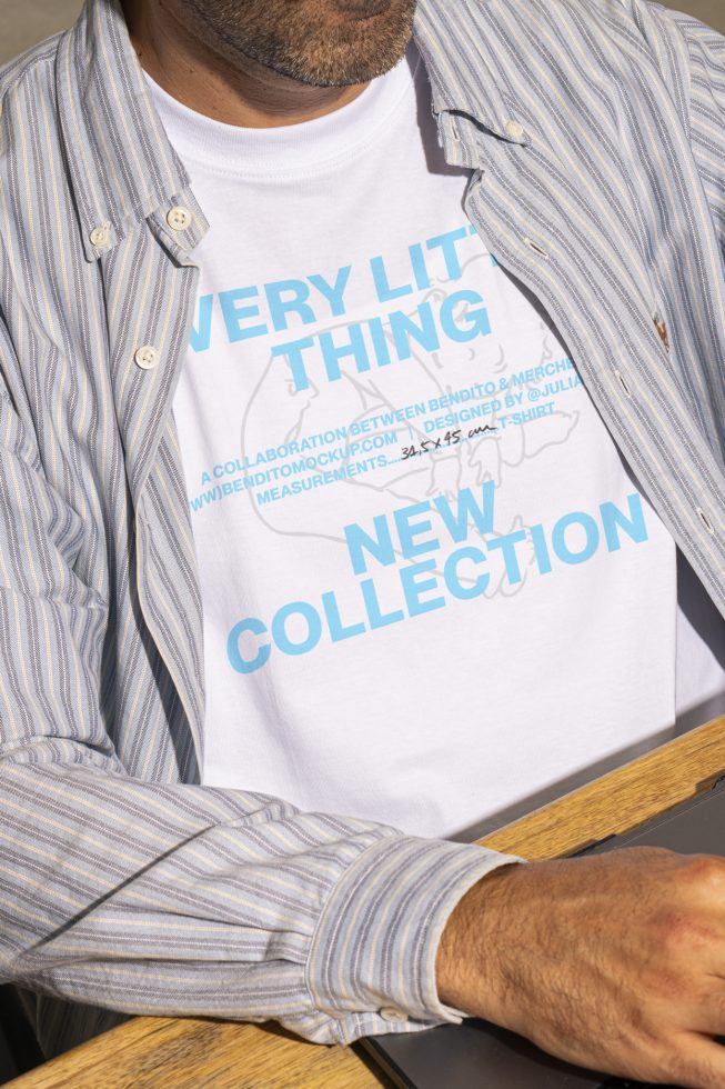 Man wearing a casual striped shirt over a white t-shirt with blue text on front, referencing a new collection; digital asset; t-shirt mockup for designers.