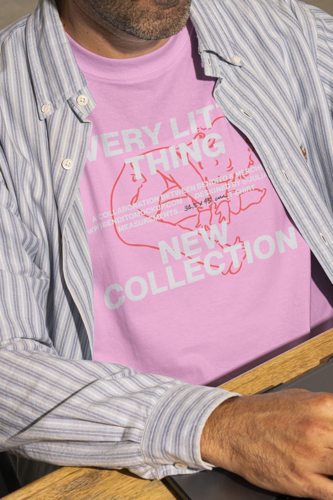 Man wearing a purple t-shirt with a printed design and a striped button-up shirt over it. Ideal for apparel mockups, t-shirt graphics designers.