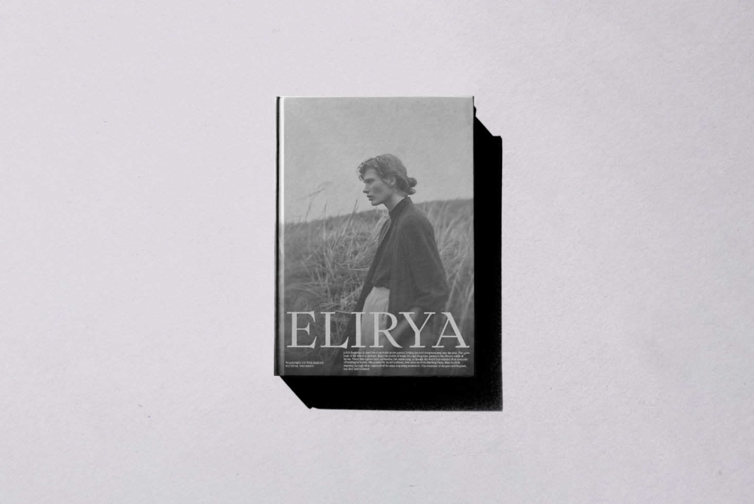 Magazine cover mockup with vintage grayscale design showcasing a person in a natural landscape scene with the title Elirya for designers.