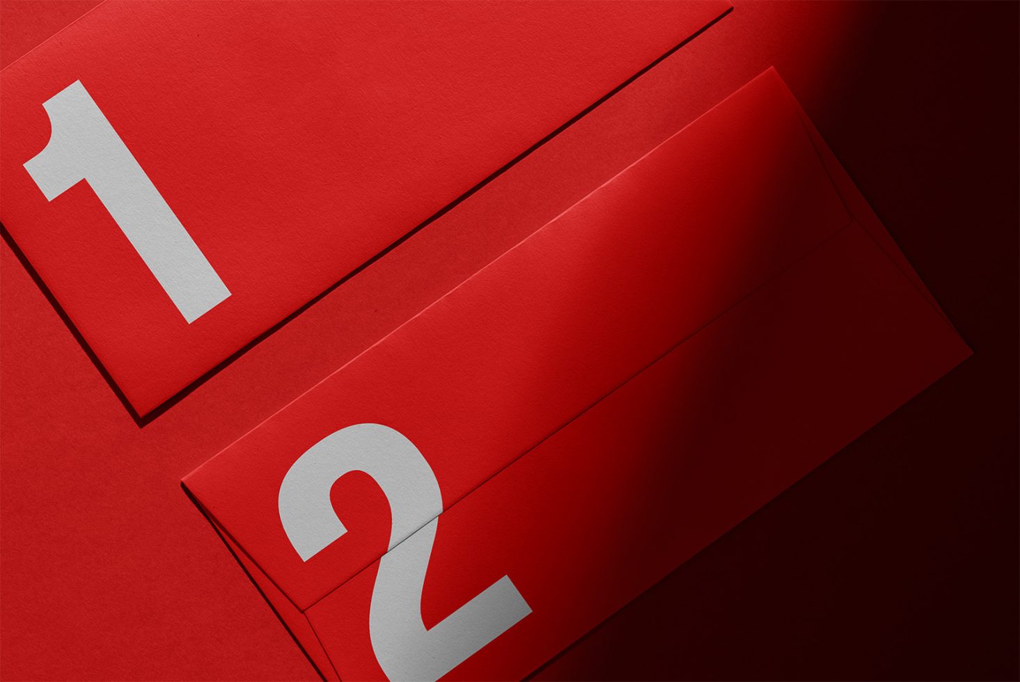 Red envelopes with white numbers one and two on them, suitable for graphic design, branding mockups, and templates for designers in need of creative assets.