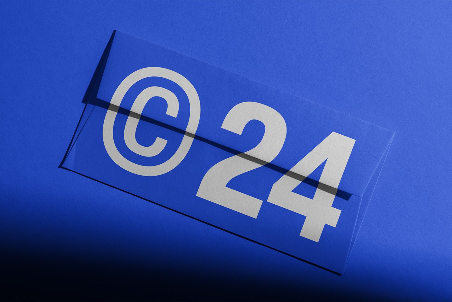 Blue background with a transparent envelope featuring a large white copyright symbol and number 24. Ideal for digital designers. Keywords: mockup, template, graphic.