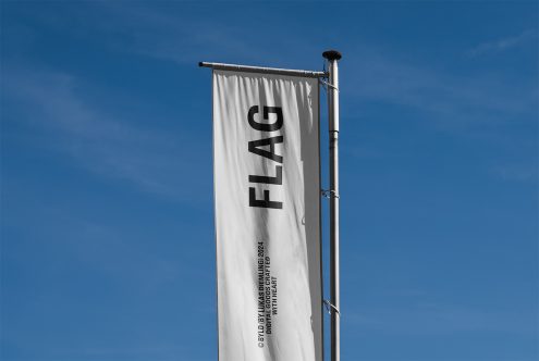 Vertical flag mockup template on a flagpole, showcasing bold black text against a white background; ideal for outdoor advertising design presentations