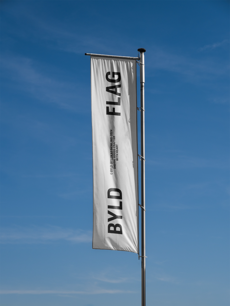 Vertical flag mockup with BYLD text on a pole against blue sky background perfect for designers showcasing branding and outdoor advertising templates.