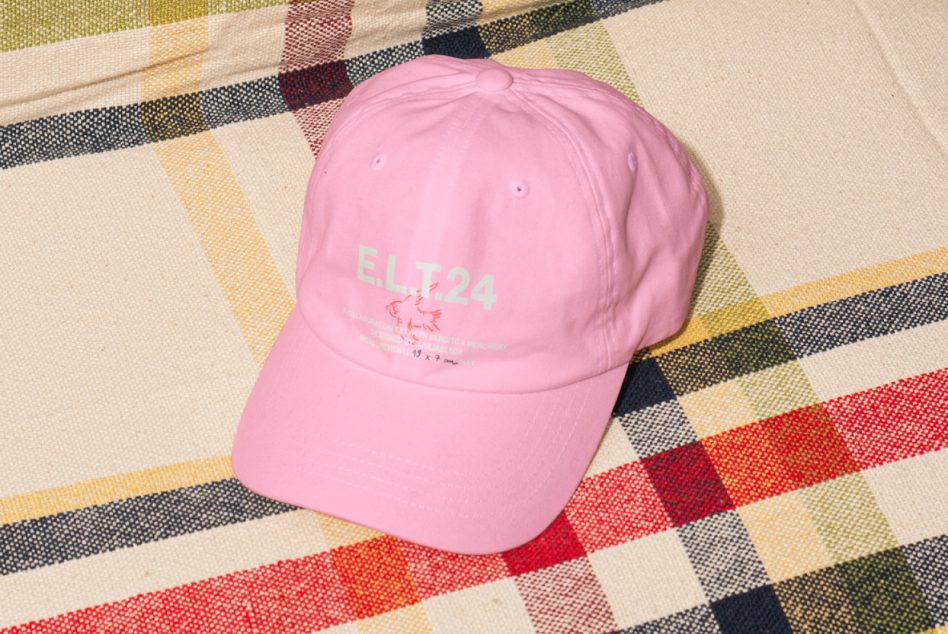 Pink baseball cap with E.LT24 lettering on a colorful plaid fabric background mockup template for designers fashion accessory graphic design photoshop asset