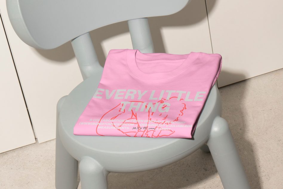 Pink T-shirt mockup with slogan Every Little Thing on pale grey chair. Ideal for showcasing apparel designs. Perfect for digital asset marketplaces.