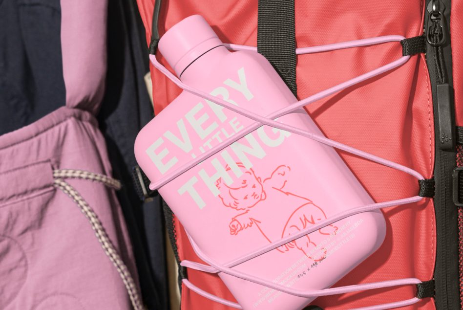 Pink water bottle on coral red backpack with pink straps, hand-drawn doodles on bottle label