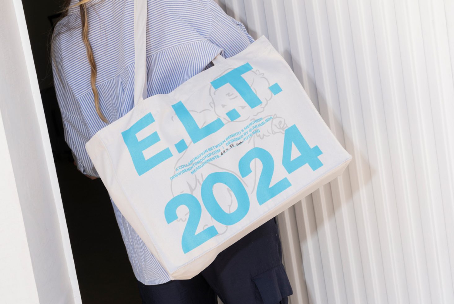 Designer tote bag mockup with bold blue text displaying ELT 2024 perfect for showcasing custom typography and graphics for digital asset marketplaces.