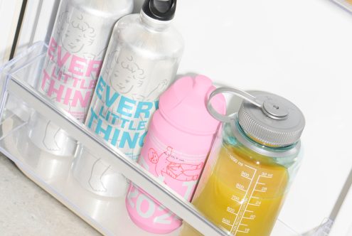 Water bottles with custom designs in pastel colors suitable for mockups and graphics. Target audience: designers seeking unique templates and creative assets.