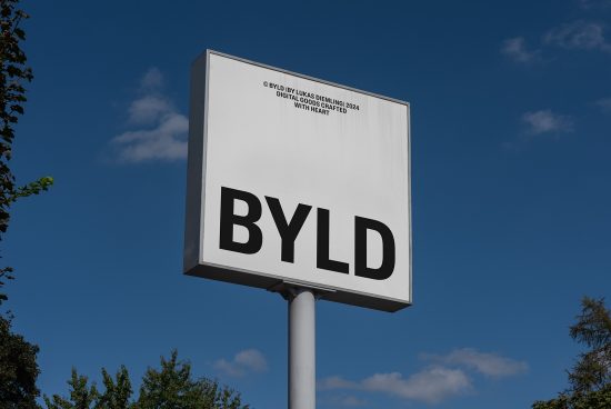 Mockup of a white outdoor sign with black typography displaying BYLD against a clear blue sky. Perfect for graphic design presentations and branding projects.