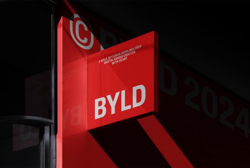 Modern storefront signage mockup featuring bold red and white branding. Ideal for showcasing logo designs, visual identities, and advertising templates.