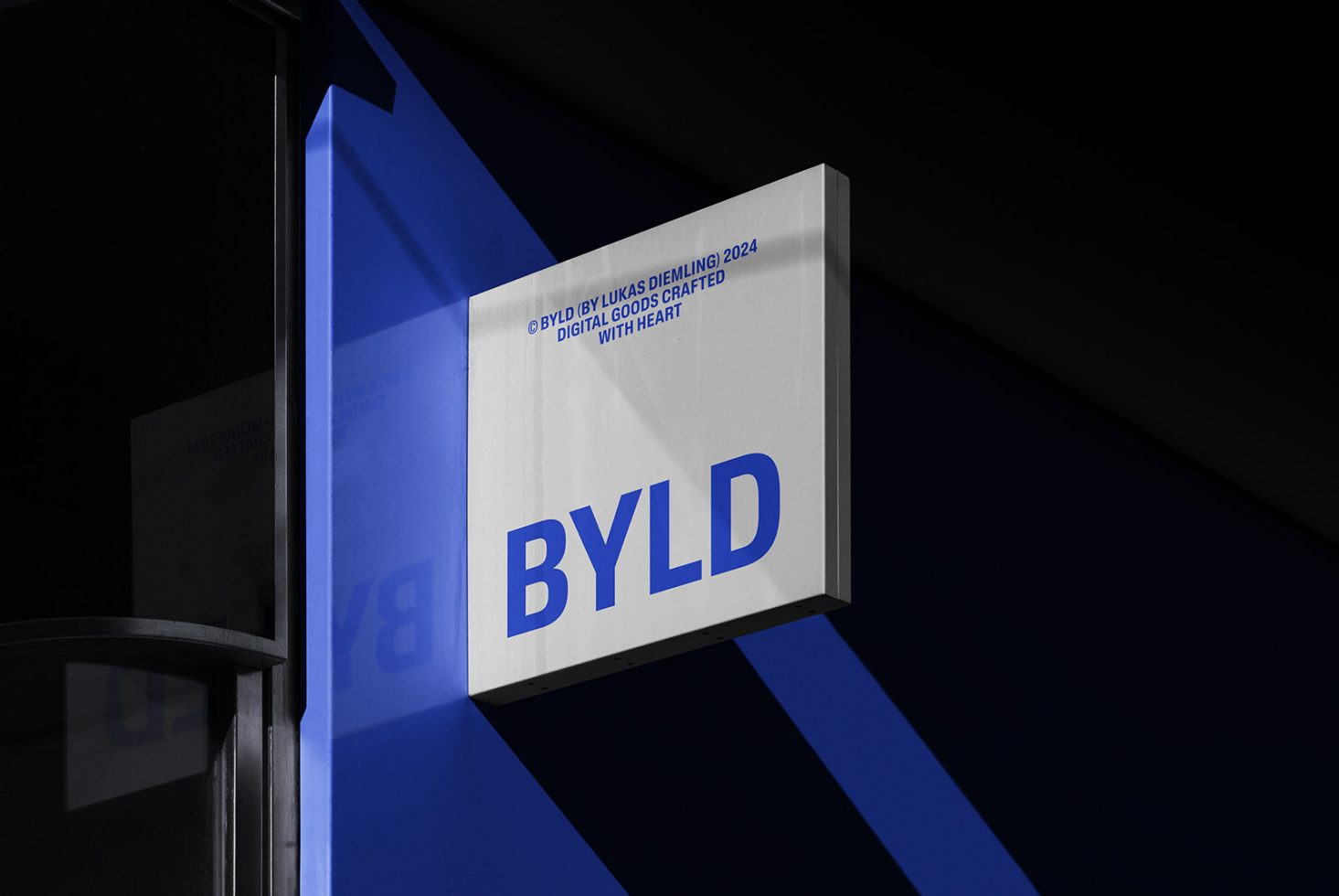 BYLD logo signage mockup on a building exterior with blue background, perfect for branding projects, digital assets, and design presentations.