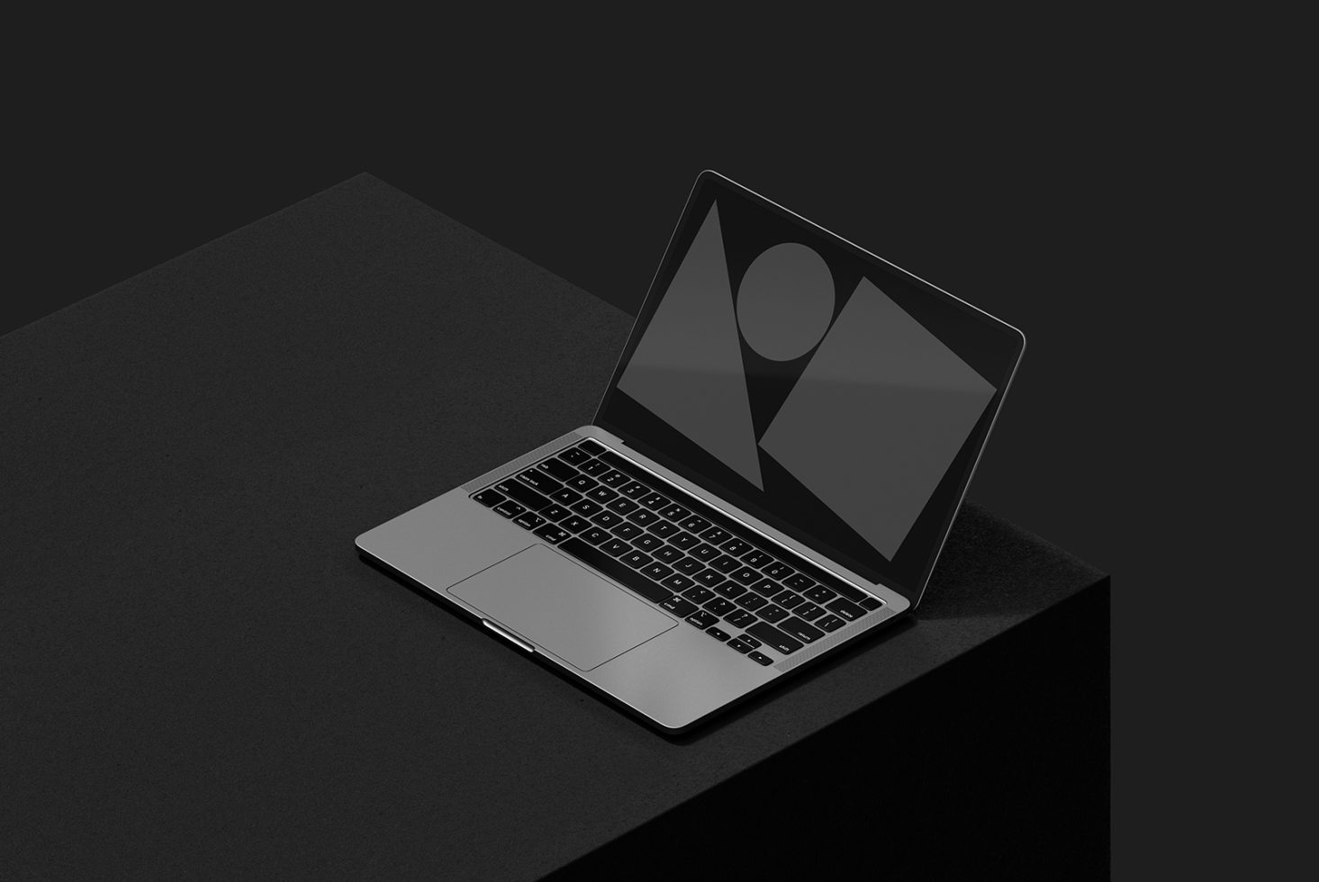 Sleek laptop mockup on dark surface showcasing geometric designs on screen. Perfect for designers seeking modern digital assets. Ideal for templates and graphics.