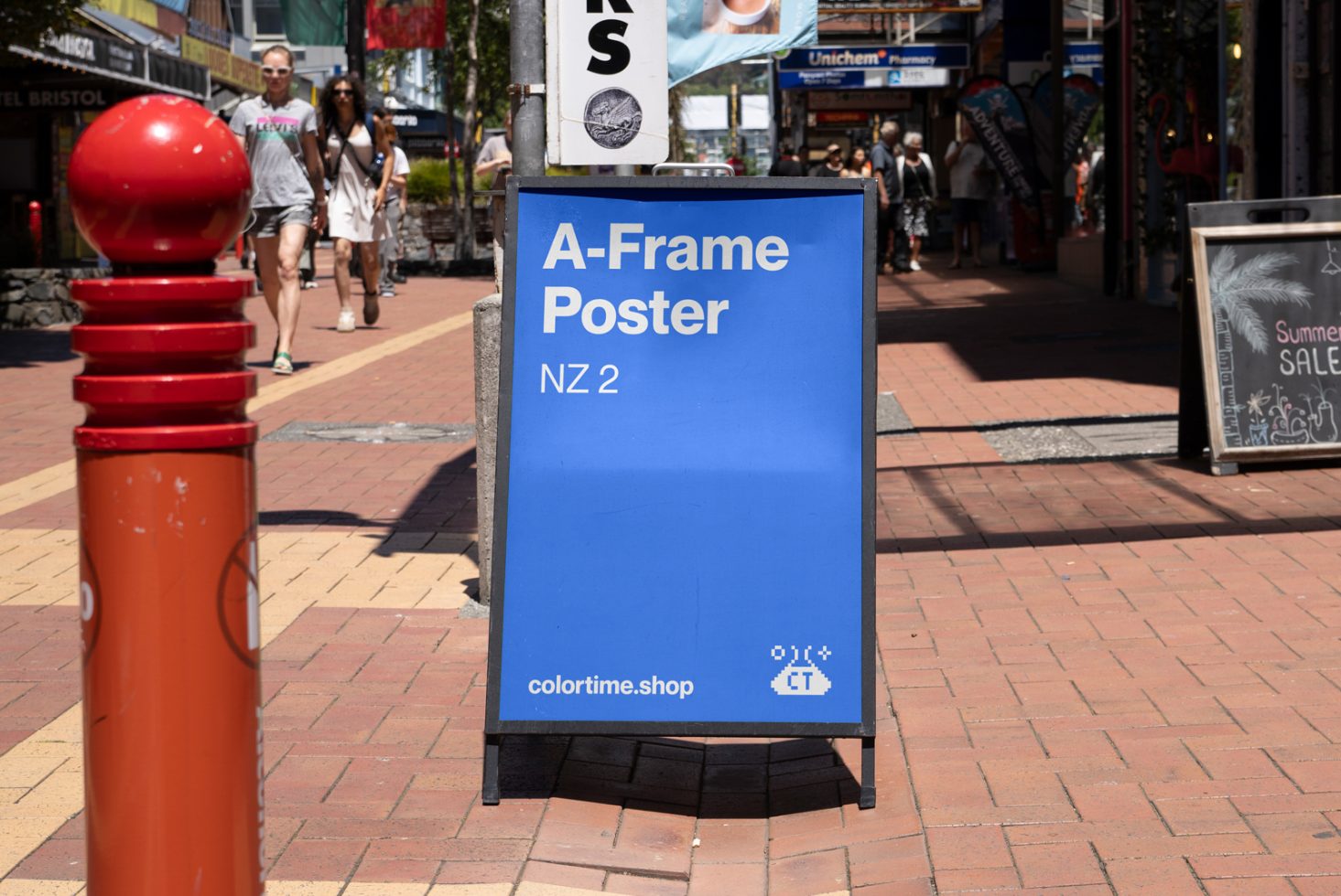 Blue A-frame poster mockup on a busy urban street featuring bold text and branding perfect for designers seeking customizable advertising templates.