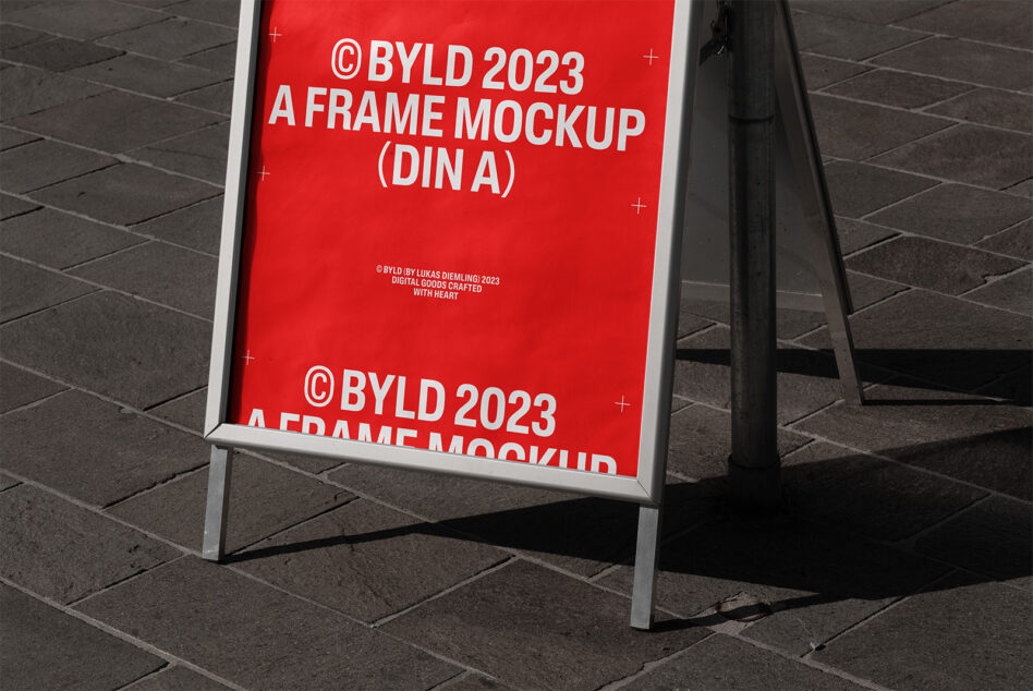 A-frame poster mockup 2023 standing on paved street. Ideal for designers seeking realistic presentation. Keywords: A-frame mockup, design, template.