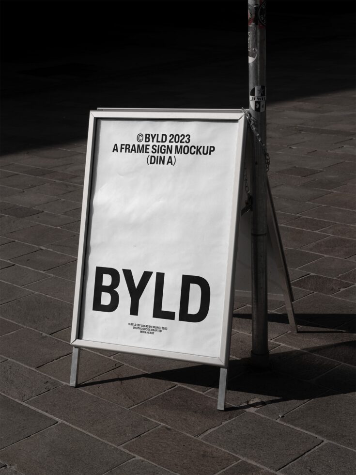 A-frame sign mockup displayed on stone pavement perfect for designers. High-quality BYLD template ideal for showcasing graphics branding and typography.