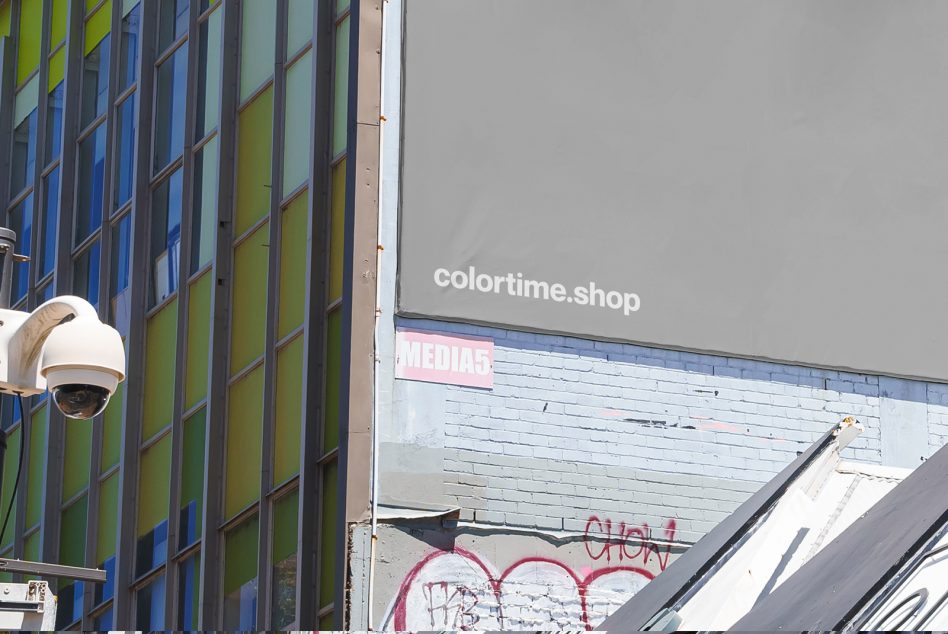 Urban building facade with colorful windows and a large blank wall for design mockups. Ideal for city graphics, advertising templates, digital assets.