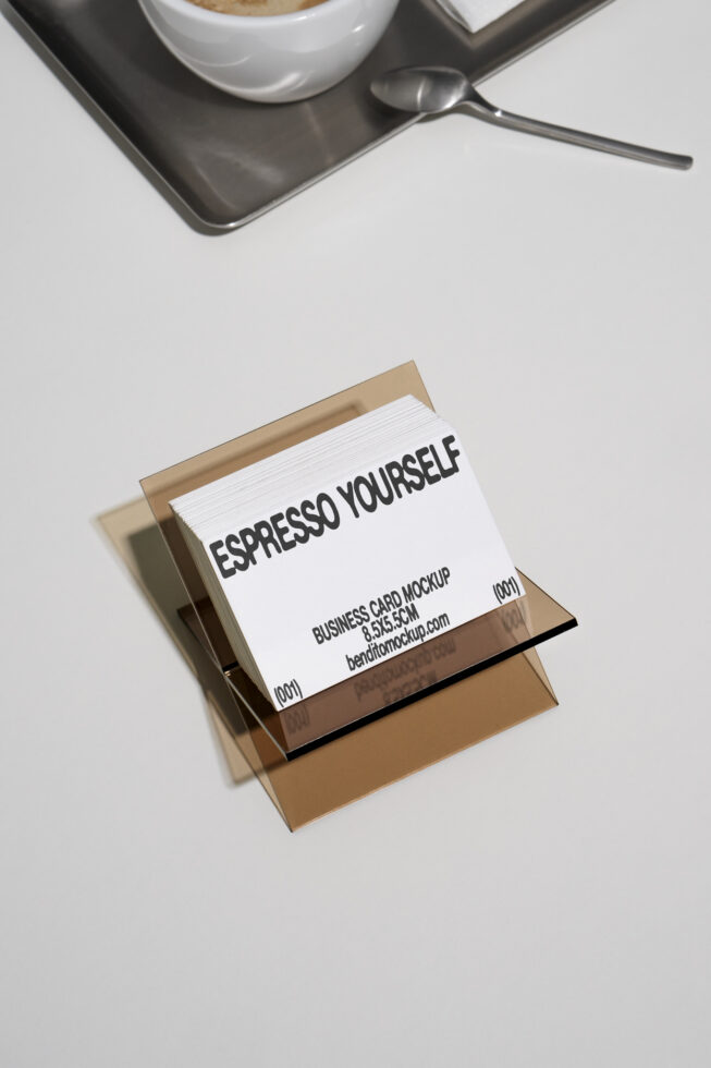 Business card mockup with coffee and spoon on white background. Espresso Yourself text. Ideal for designers, templates, branding, and graphic resources.