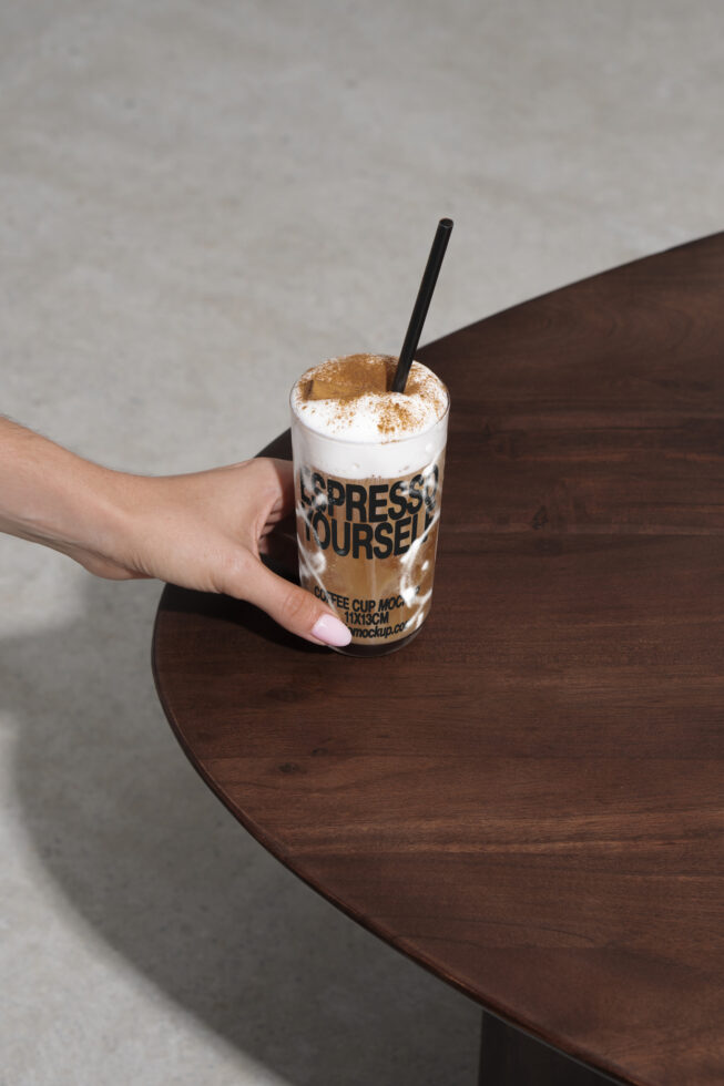 Coffee cup mockup on dark wood table, hand holding cup with text express yourself, design asset for designers, mockup, branding, digital graphics.