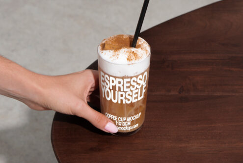 Hand holding a coffee cup mockup with text Espresso Yourself. Suitable for designers in Mockups category. Perfect for showcasing coffee branding.