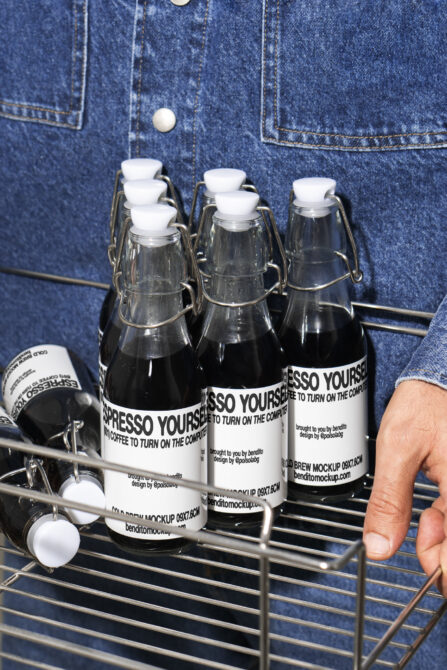 Cold brew bottle mockup with modern typography design in a metal basket. Ideal for designers seeking trendy label templates and branding graphics.