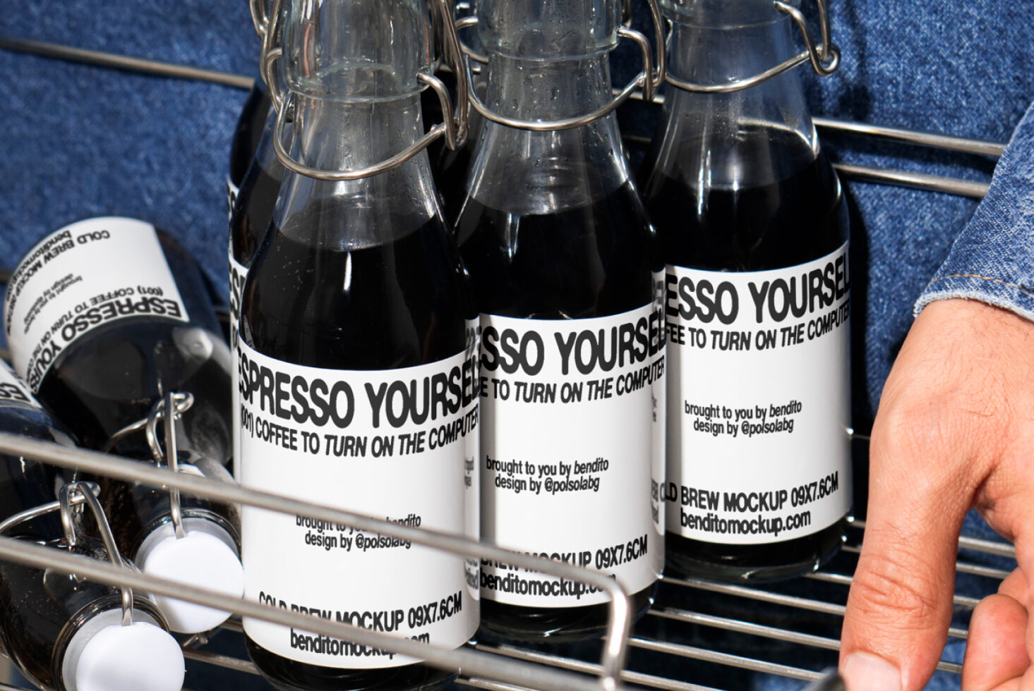 Close-up of glass bottles with Espresso Yourself labels in a wire basket. Perfect for mockup designs for digital assets. Coffee branding, packaging.